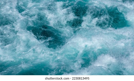 Water texture. Huka Falls, Taupo, New Zealand.

Huka Falls is a set of waterfalls along the Waikato River, which drain Lake Taupō. Water rushes through the falls creating a series of violent rapids. - Shutterstock ID 2230813495