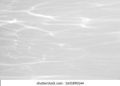 Water texture overlay effect for photo and mockups. Organic drop diagonal shadow and light caustic effect on a white wall.