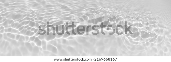 Water texture with wave sun reflections on the\
water overlay effect for photo or mockup. Organic light gray drop\
shadow caustic effect with wave refraction of light. Long Banner\
with copy space.