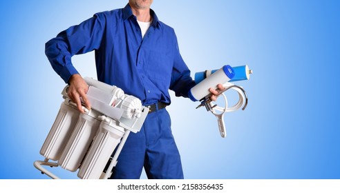 Water Treatment Technician With Tools And Spare Parts For The Maintenance And Repair Of Reverse Osmosis In The Hands Dressed In Work Clothes With Blue Gradient Background. Front View.