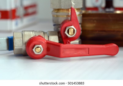 water valve with red handle. ball valve used in plumbing and heating systems. plumbing fittings