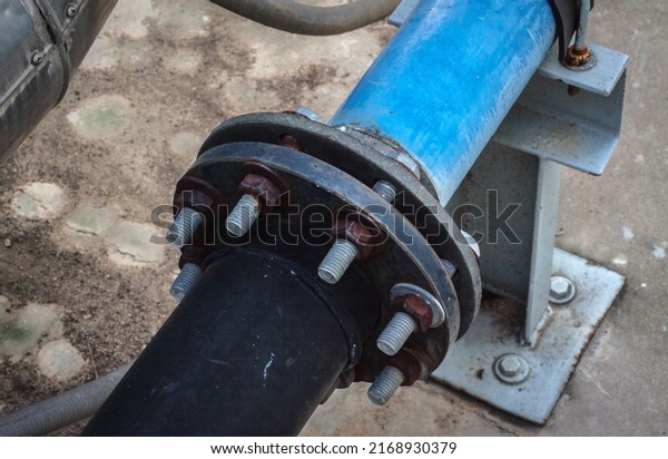 water valve. Rusty and dirty hot water shut-off
valve.water supply. Galvanized steel pipe with tee, elbow, fitting
and valve, water piping system.measurement. valve. old plug sockets
at a wall.