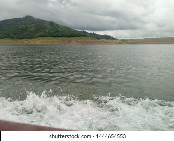 Water waves while sitting on the boat watching the dam  Beautiful view with mountain