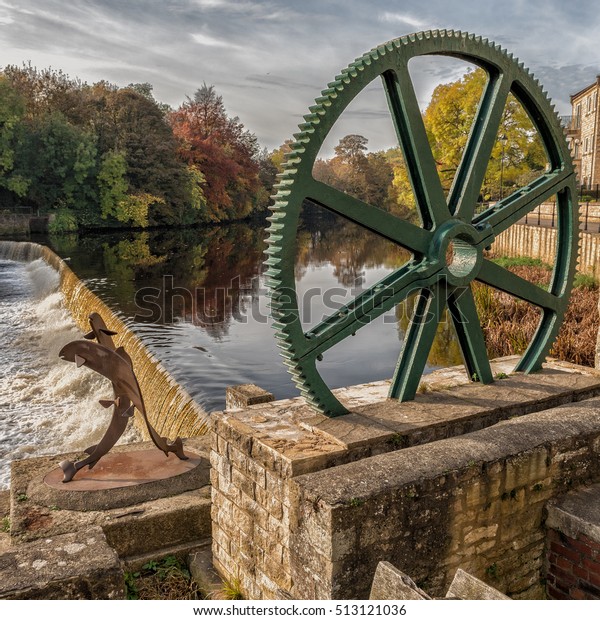  Water wheel by the\
bridge and weir at Wetherby. The wheel belonged to a mill that\
stood on the site and now used as a feature. THe River Wharfe is in\
the background