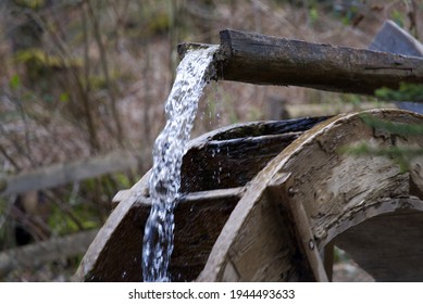 Water wheel in the forest at springtime at City of Zürich. Photo taken March 27th, 2021, Zurich, Switzerland.