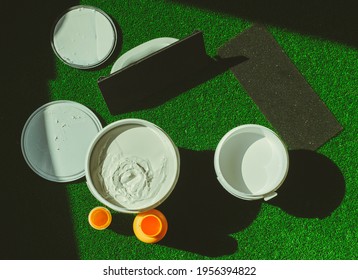 Water-based Paint Repair Concept. White And Yellow Paint On Artificial Grass. Paint, Concept,