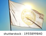 Waterbury of Connecticut of United States flag waving on the wind in front of sun