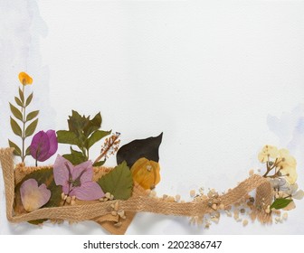 Watercolor Background On Paper With Copy Space, Decorated With Dried And Pressed Flowers And Leaves, Petals, Stones And Woven Fique For Greeting Card, Wedding Or Invitation