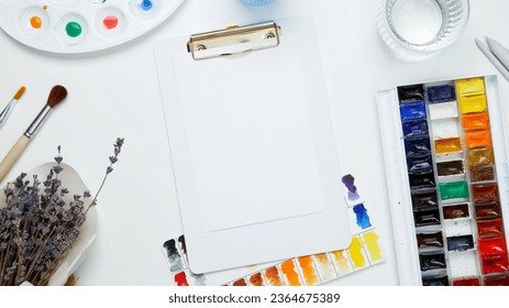 Watercolor and other artistic accessories on a white background. Artist's desk workplace. Top view, copy space, flatlay - Shutterstock ID 2364675389