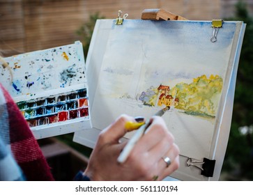 Watercolor Painting With Brush At The Easel 