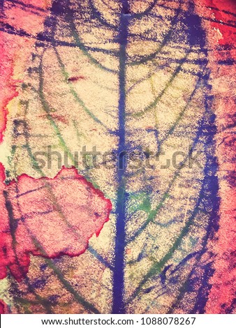 Watercolor painting of leaves in painted background. Paper with full painted watercolor surface.