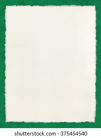 Watercolor paper with true deckled edges on a green background.  File includes a clipping path.