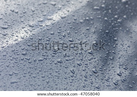 Waterdrops on a darkgray metallic car