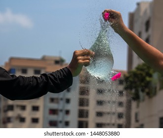 Watered Ballon Burst,A Ballon Was Filled Up With Water And Burst To Capture The Way Water Splashes