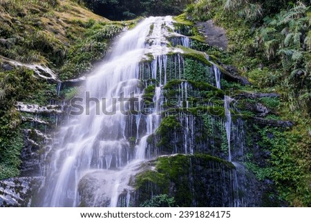 A waterfall with abundant water flow in winter. White silver chain. Sun-Link-Sea Forest and Nature Resort in Nantou County, Taiwan.