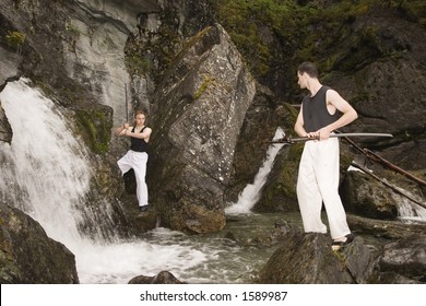 Waterfall area is a nice place to practice fencing outdoor. Two man with katanas