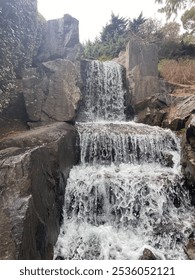Waterfall in between rocks with trees