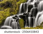 Waterfall with black stones, Portree, Isle of Skye, Scotland, United Kingdom, Europe