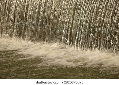 A waterfall, capturing the texture and movement of cascading water.