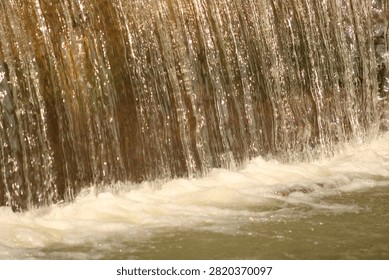 A waterfall, capturing the texture and movement of cascading water.