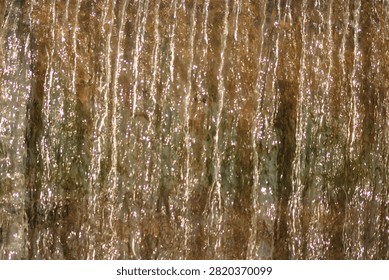 A waterfall, capturing the texture and movement of cascading water.