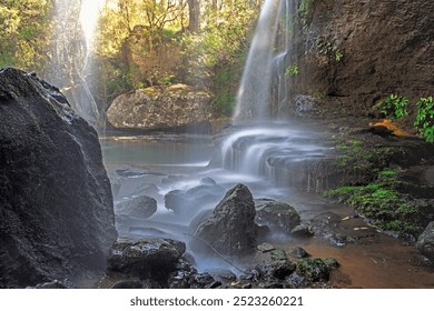 Waterfall cascades over rock ledges as it meanders through beautiful Australian bushland - Powered by Shutterstock