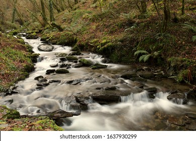 A Waterfall Cascading Through A Valley Floor. Slow Shutter Speed To Blur Water. Focus In Lower Third.