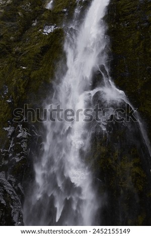 Waterfall coming down on the mossy rocks