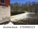 Waterfall dam flowing into Sheboygan river at Settlers Park in Sheboygan Falls, Wisconsin 