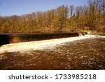 Waterfall dam flowing into Sheboygan river at Settlers Park in Sheboygan Falls, Wisconsin 