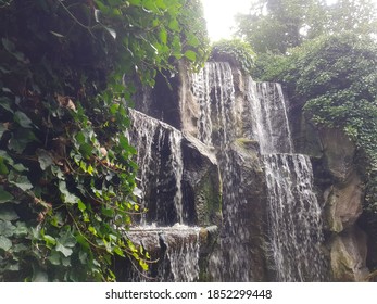 Waterfall in daylight surrounded by green foliage