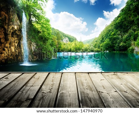 waterfall in deep forest of croatia and wood pier