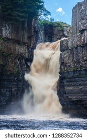 Waterfall With Dirty Water; High Force Is One Of The Biggest Waterfalls In England And Is Popular By Tourists. High Force Is Located Near Middleton-in-Teesdale In The North Pennines, England. 