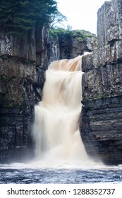 Waterfall With Dirty Water; High Force Is One Of The Biggest Waterfalls In England And Is Popular By Tourists. High Force Is Located Near Middleton-in-Teesdale In The North Pennines, England. 