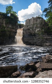 Waterfall With Dirty Water; High Force Is One Of The Biggest Waterfalls In England And Is Popular By Tourists. High Force Is Located Near Middleton-in-Teesdale In The North Pennines, England. 