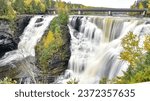 Waterfall with fall foliage and creamy water