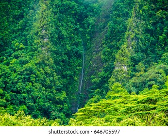 A Waterfall Flowing Down The Mountain At Hoomaluhia Botanical Gardens