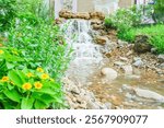 Waterfall is flowing in jungle,Waterfall flowing through rocks in green forest,Stream of water in the forest, Cascading stream in lush forest. Nature background. Rock or stone at waterfall.