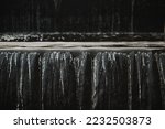A waterfall flowing at park Wall of water A beautiful view of the falling water cascade city fountain close-up pouring