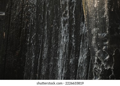 A waterfall flowing at park Wall of water A beautiful view of the falling water cascade city fountain close-up pouring - Shutterstock ID 2226633819