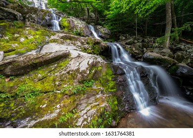 Waterfall flowing through green forest at Shenandoah National Park, VA.
