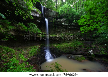Waterfall flows into a deep canyon in the woodland of northern Alabama