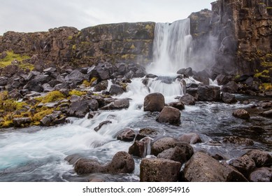 The Öxarárfoss waterfall flows out the river Öxará, cascading in two drops over the cliffs of Almannagjá gorge, which marks the eastern boundary of the North American and Eurasian tectonic plates. 