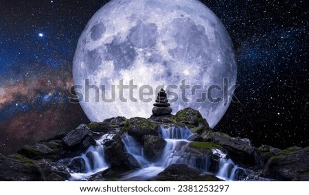 Waterfall in the foreground with the full moon