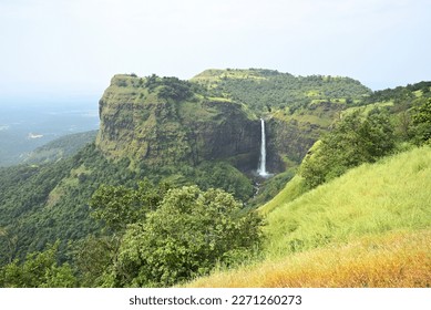 Waterfall in green mountains at distance. - Shutterstock ID 2271260273