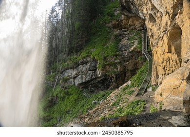  waterfall from a high cliff. water flow down.Streams of water crash on rocks and boulders. stormy stream of water with drops and splashes