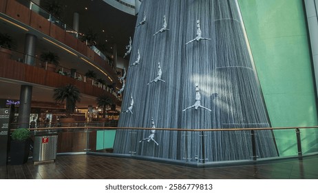 Waterfall Inside of the Mall with crowd making pictures, worlds largest shopping mall, Dubai, United Arab Emirates 