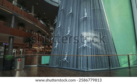 Waterfall Inside of the Mall with crowd making pictures, worlds largest shopping mall, Dubai, United Arab Emirates 
