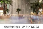 Waterfall Inside of the Mall with crowd of people near by, worlds largest shopping mall, Dubai, United Arab Emirates timelapse