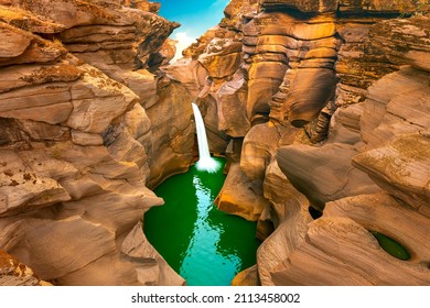 Waterfall Landscape In Nature. Spectacular Nature View With The Waterfall Pouring Through The Huge Rocks. Waterfall View In Red Canyon. Nature Landscape In The Mountain. 